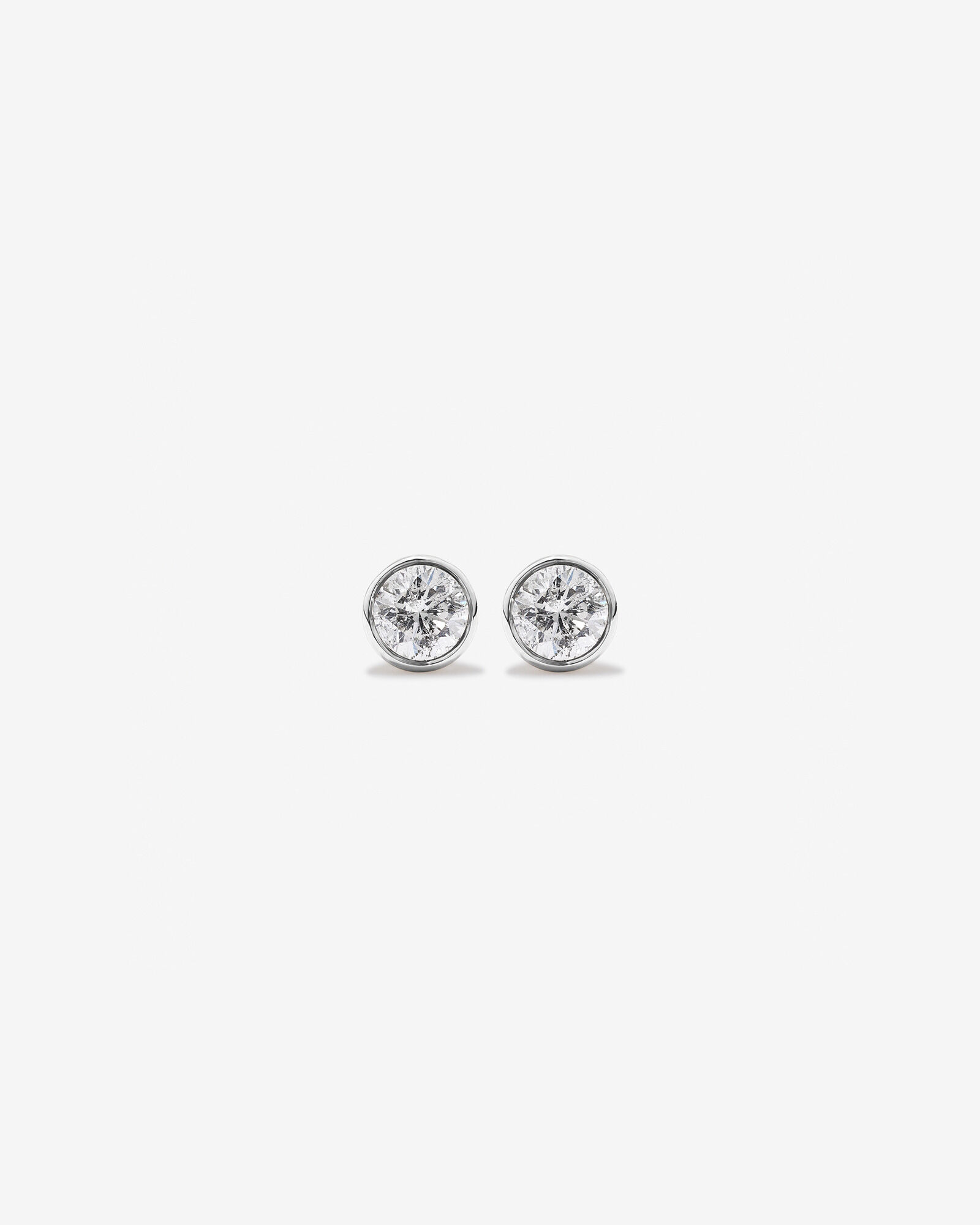 0.25 Carat TW Round Brilliant Diamond Solitaire Bezel Set Stud Earrings 18kt White Gold