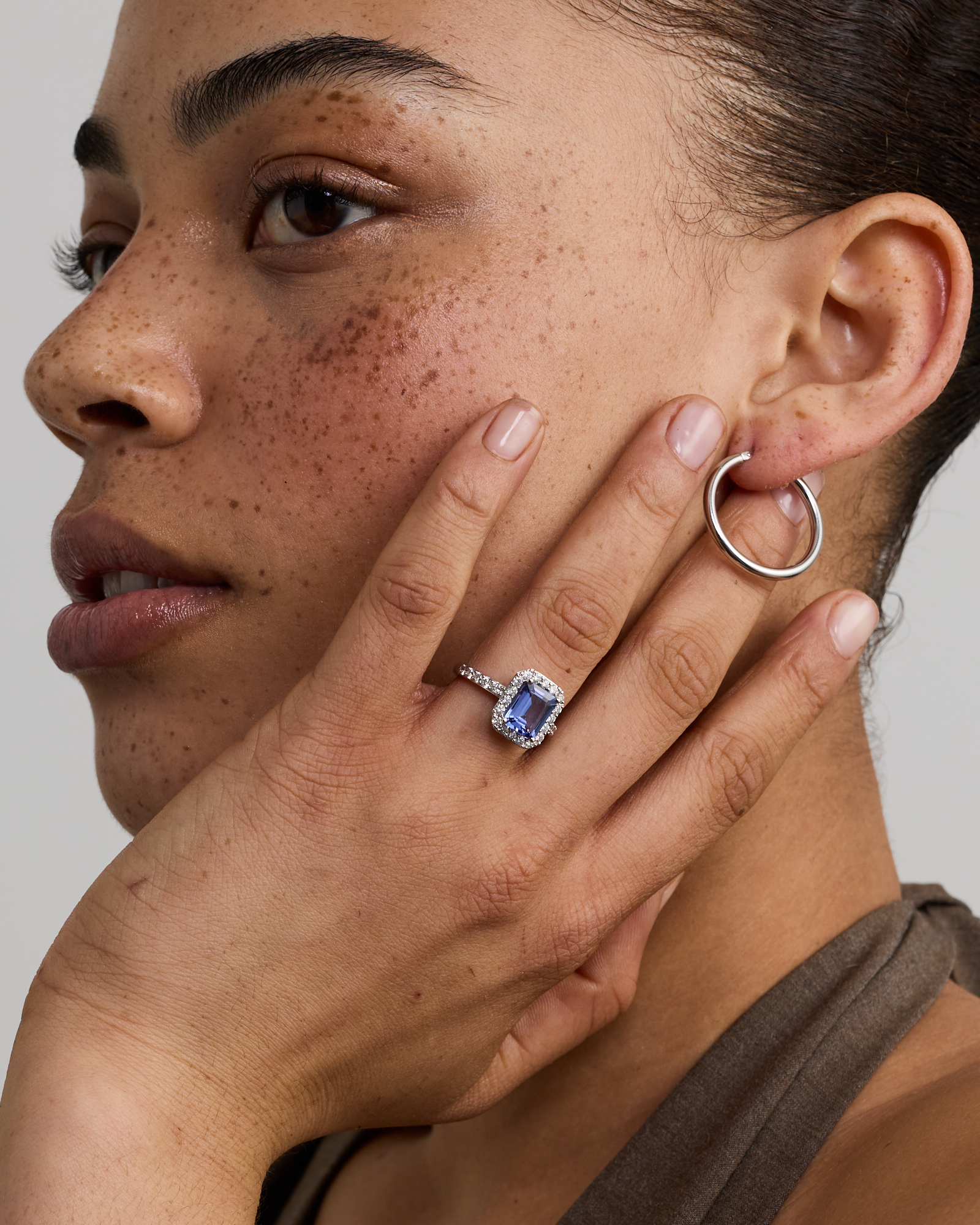 Emerald Cut Blue Tanzanite Gemstone and 0.75 Carat TW Diamond Halo Ring in 14kt White Gold