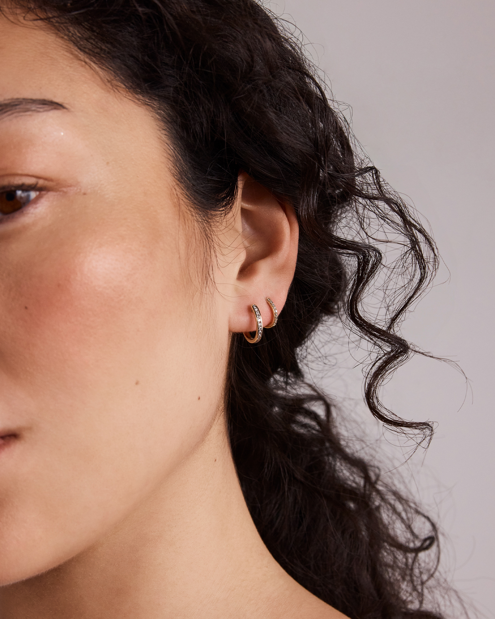 0.25 Carat TW Channel Set Round Brilliant Diamond Huggie Hoop Earrings in 10kt Yellow Gold