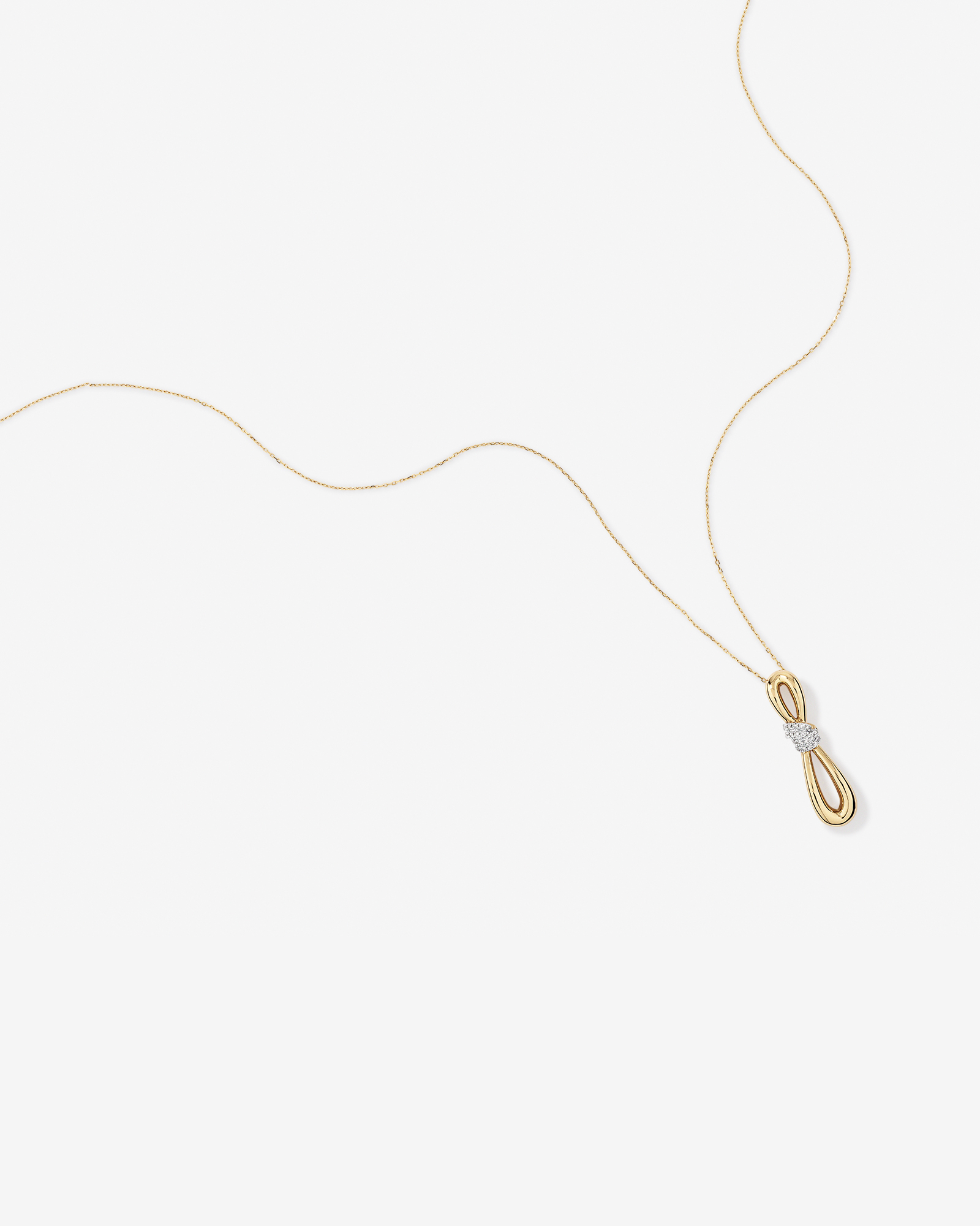 0.17 Carat TW Diamond Knot Pendant in 10kt Yellow Gold