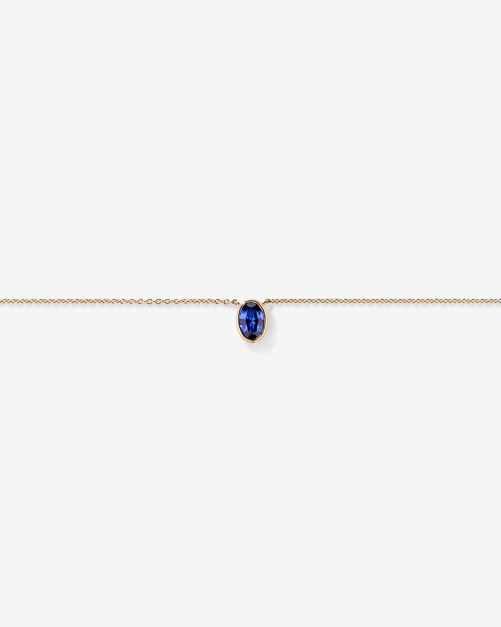Oval Blue Created Sapphire Bezel Necklace in 10kt Yellow Gold