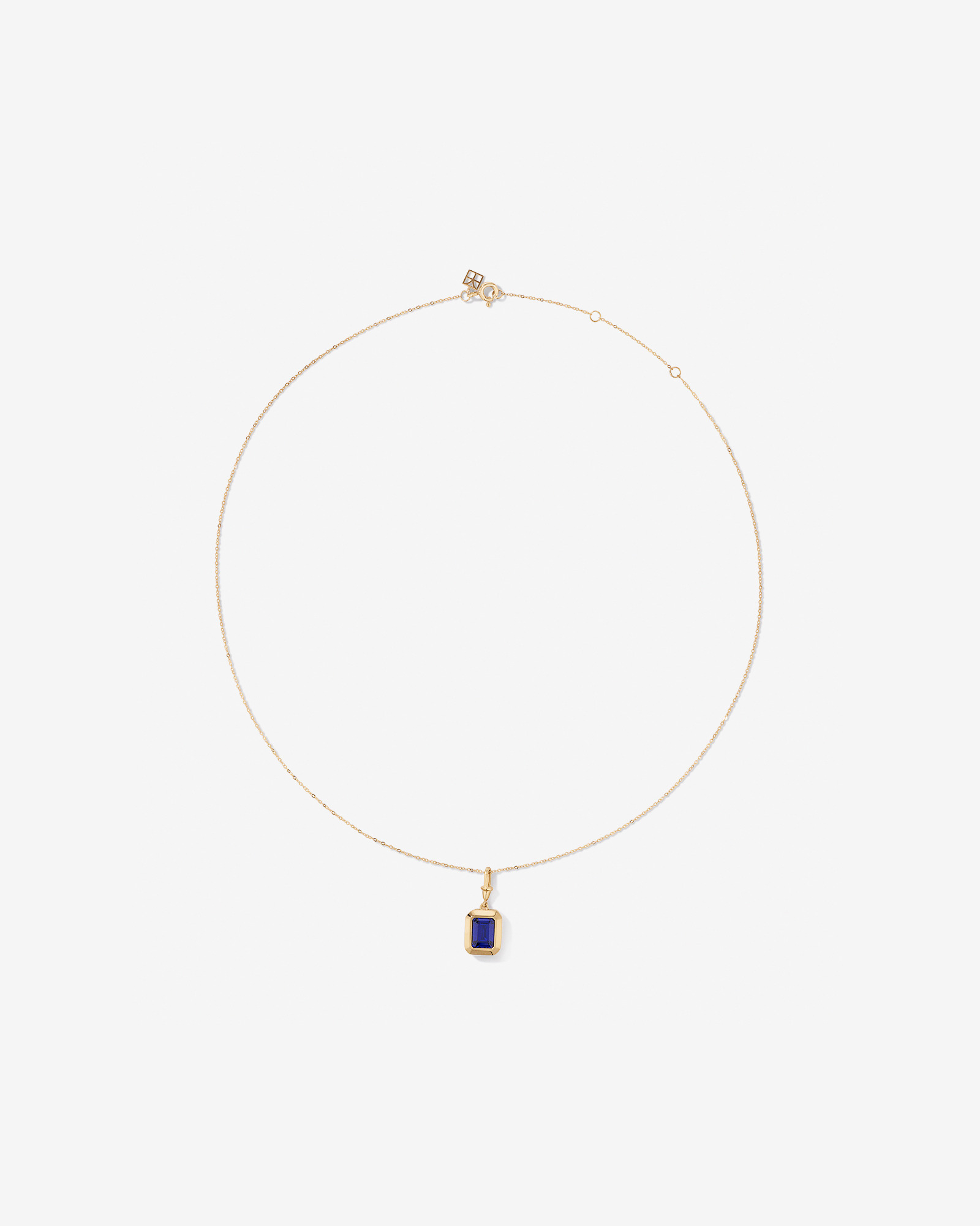 Emerald Cut Created Sapphire Bezel Pendant with Chain in 10kt Yellow Gold