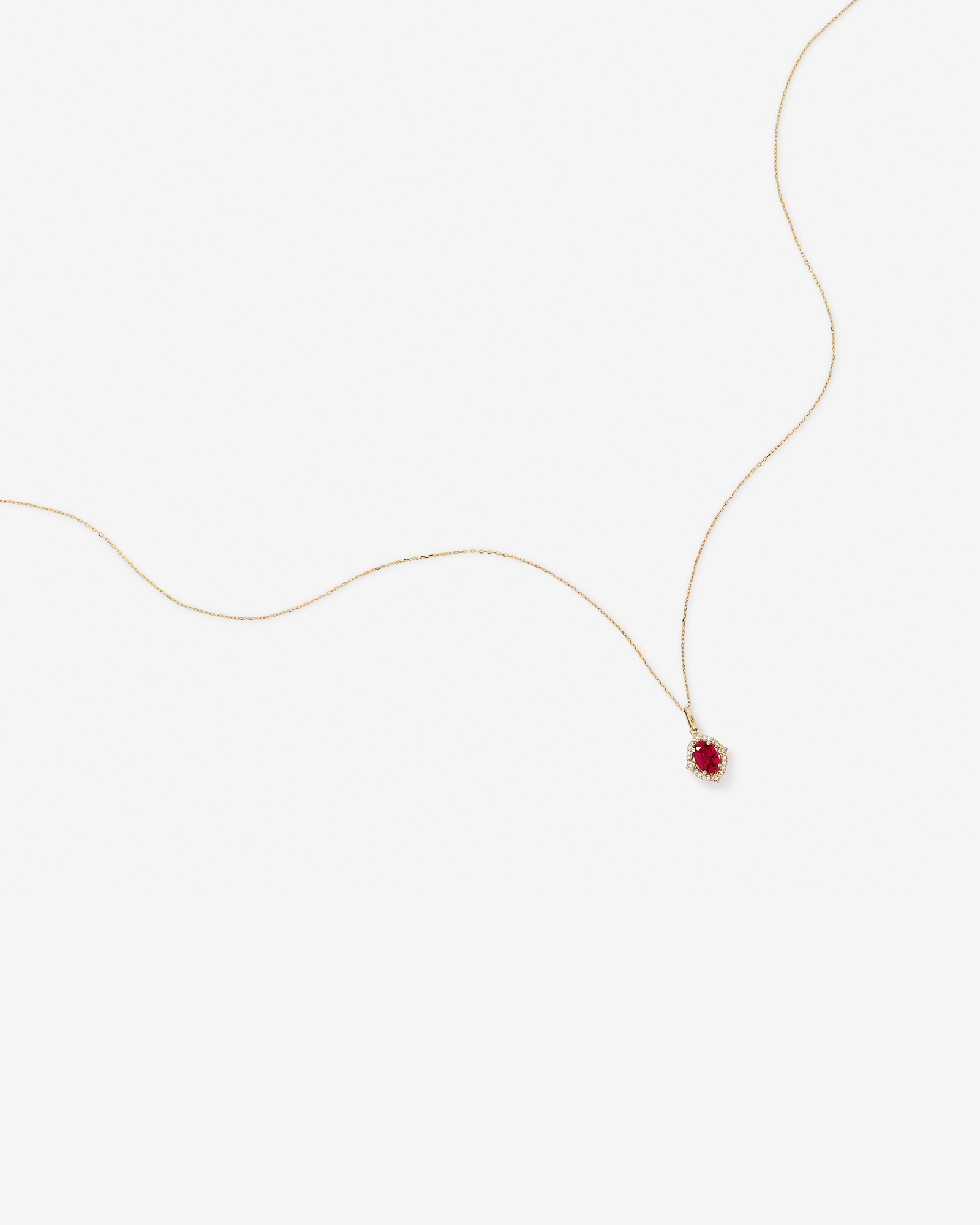 Oval Cut Created Ruby and Diamond Halo Pendant Necklace in 10kt Yellow Gold