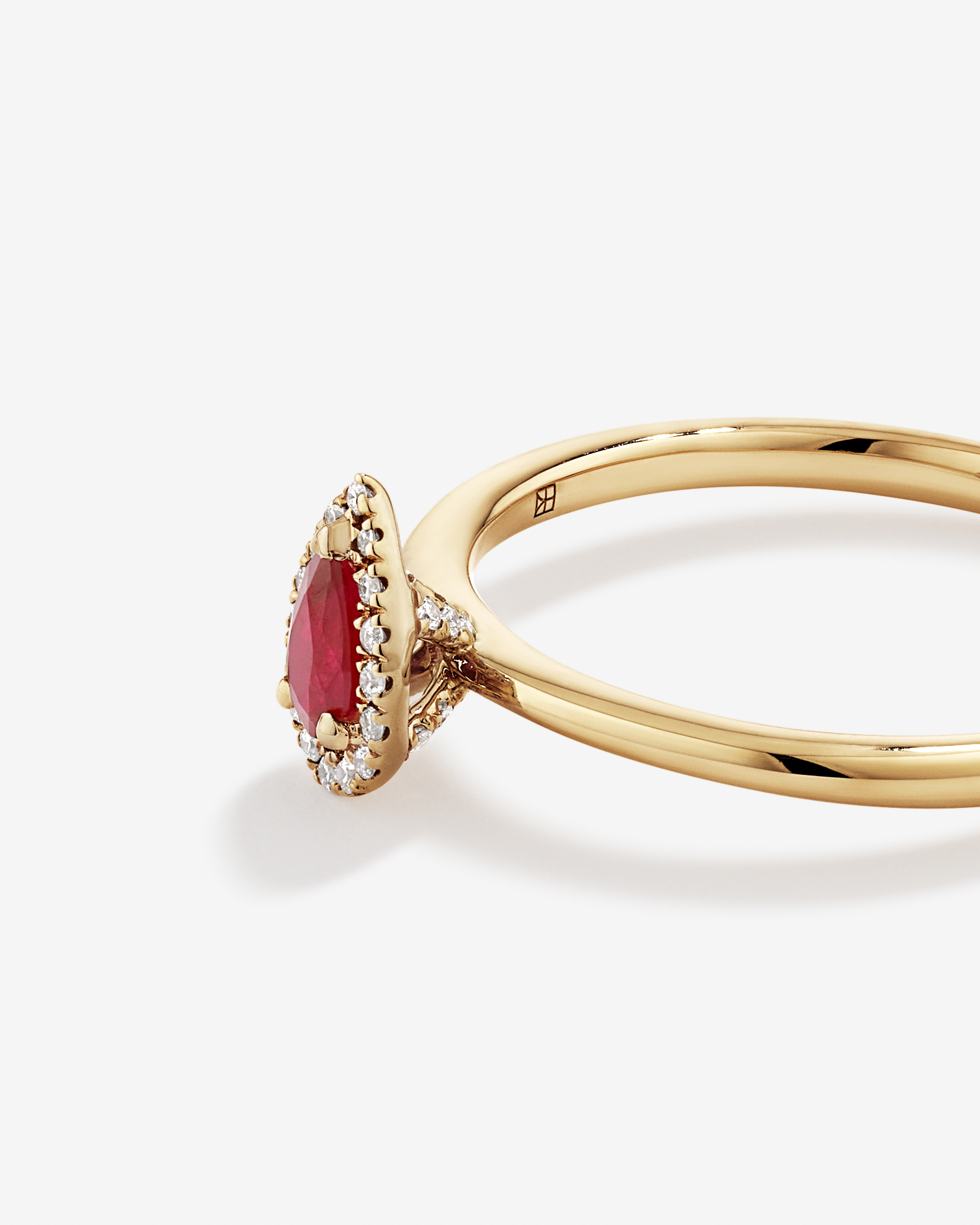 Pear Cut Red Ruby Gemstone and 0.08 Carat TW Diamond Halo Ring in 10kt Yellow Gold