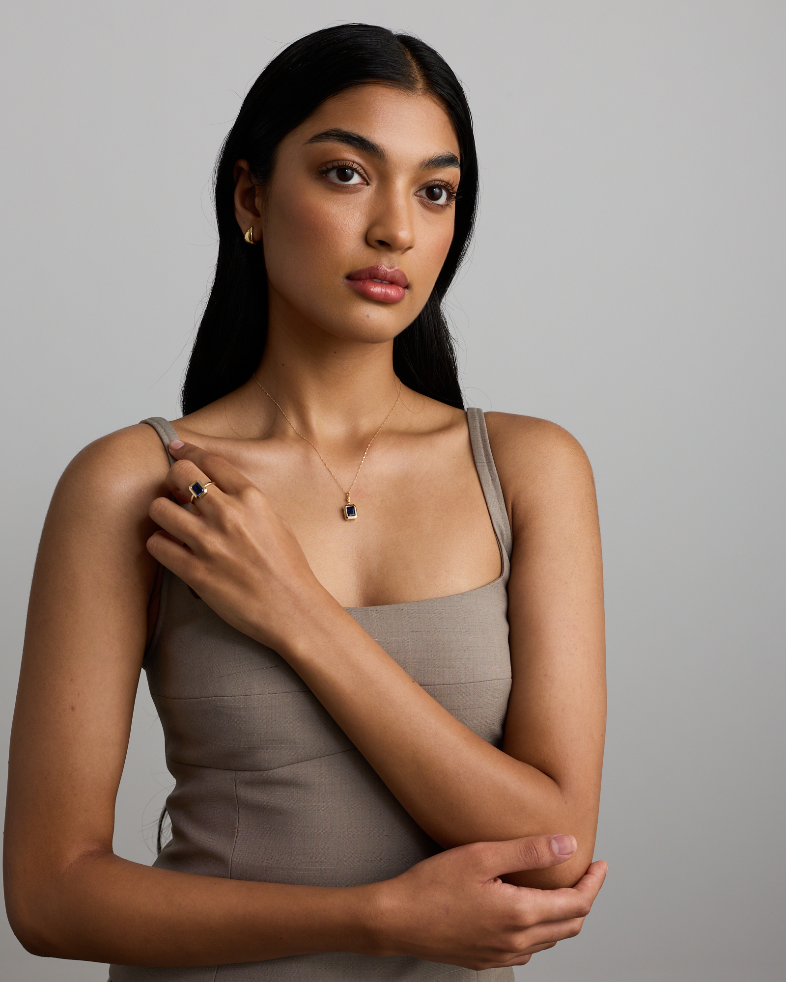 Emerald Cut Created Sapphire Bezel Pendant with Chain in 10kt Yellow Gold