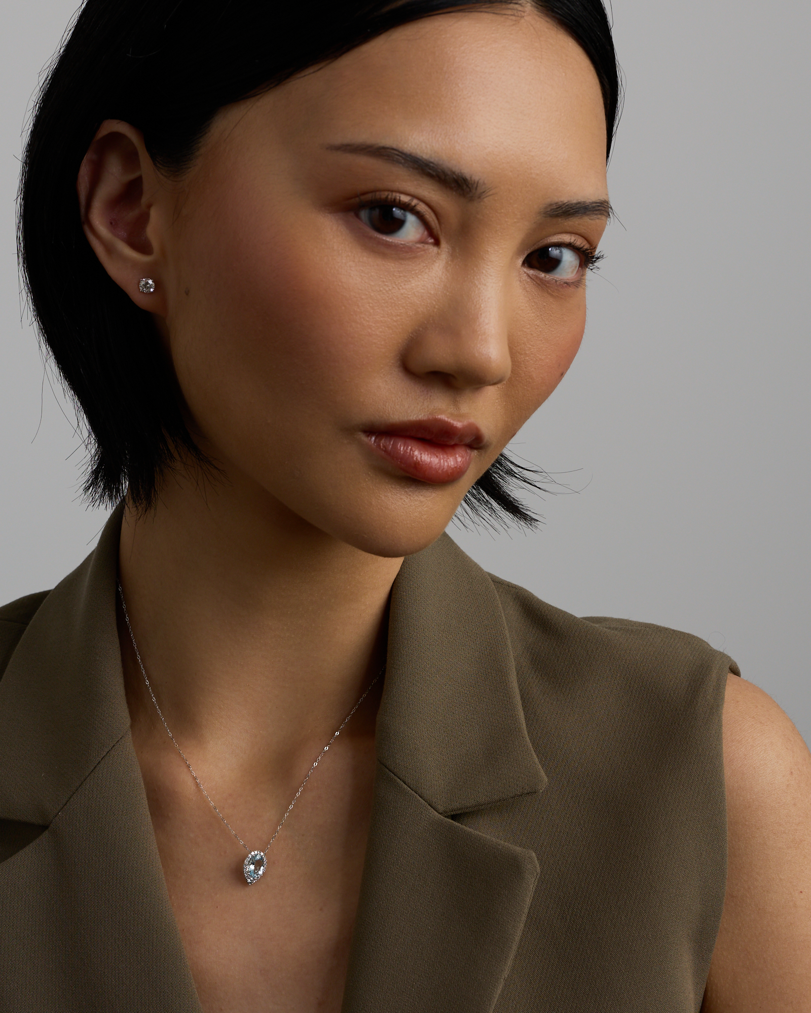 Oval Cut Blue Aquamarine Gemstone and 0.19 Carat TW Diamond Halo Pendant Necklace in 10kt White Gold