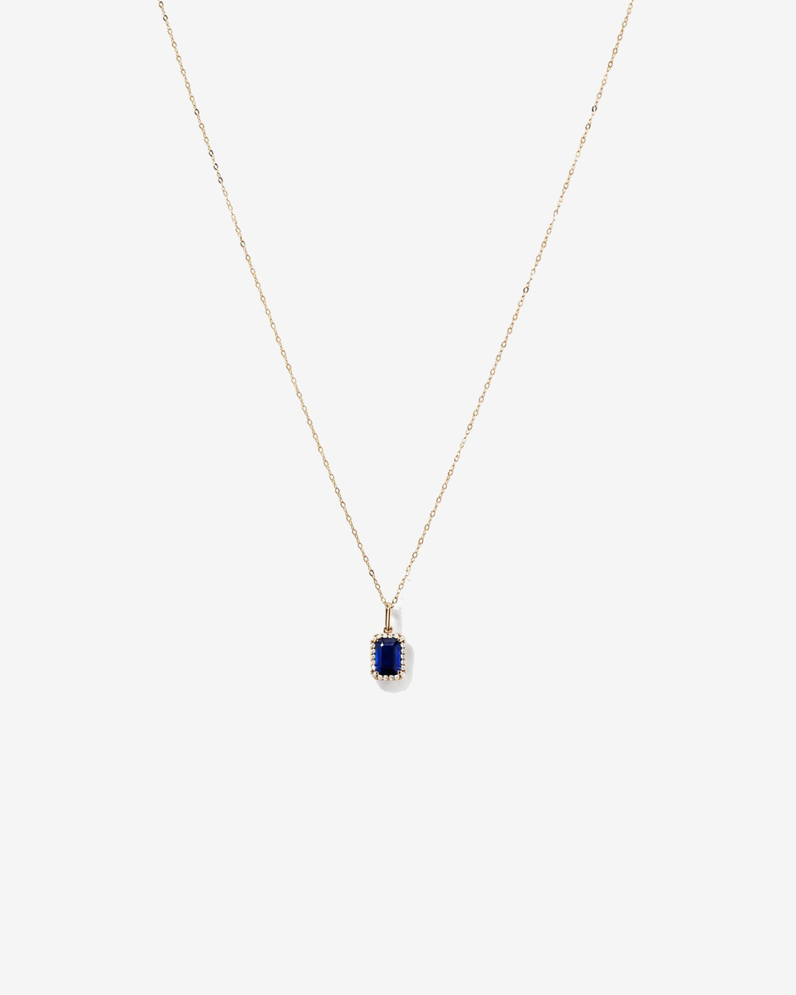 Emerald Cut Created Sapphire and Diamond Halo Pendant with Chain in 10kt Yellow Gold