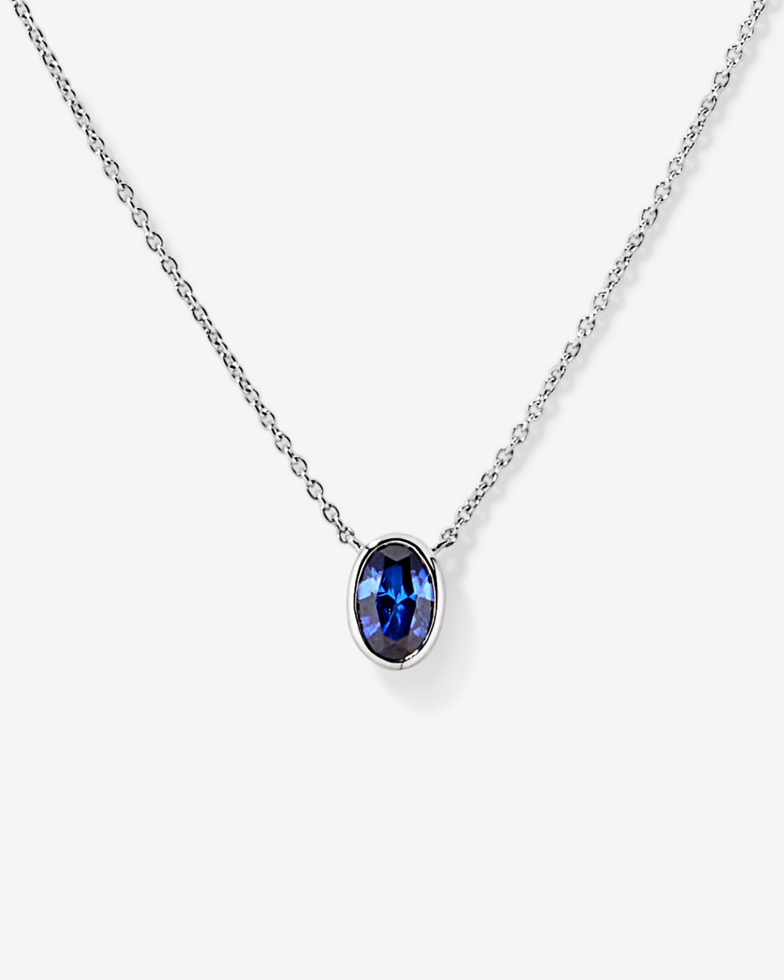 Oval Blue Created Sapphire Bezel Necklace in 10kt White Gold