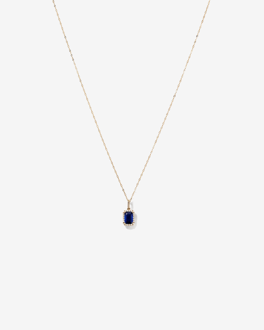 Emerald Cut Created Sapphire and Diamond Halo Pendant with Chain in 10kt Yellow Gold