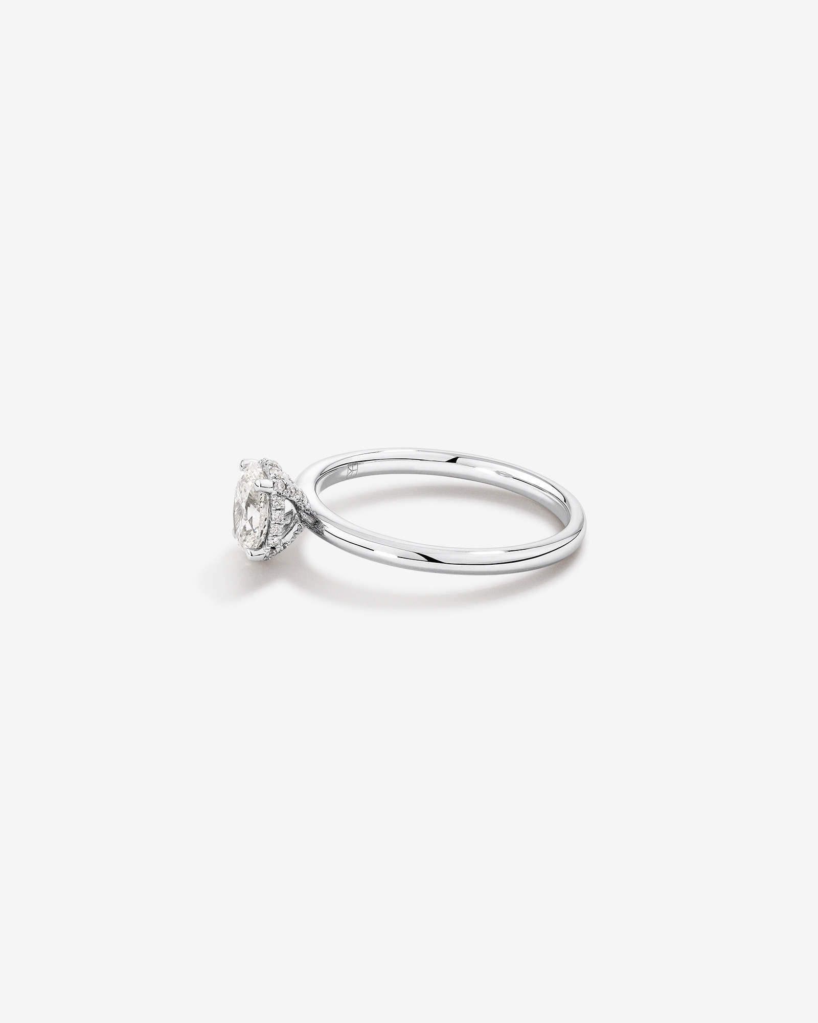 0.68 Carat TW Oval Cut Diamond Solitaire Hidden Pave Halo Engagement Ring in Platinum