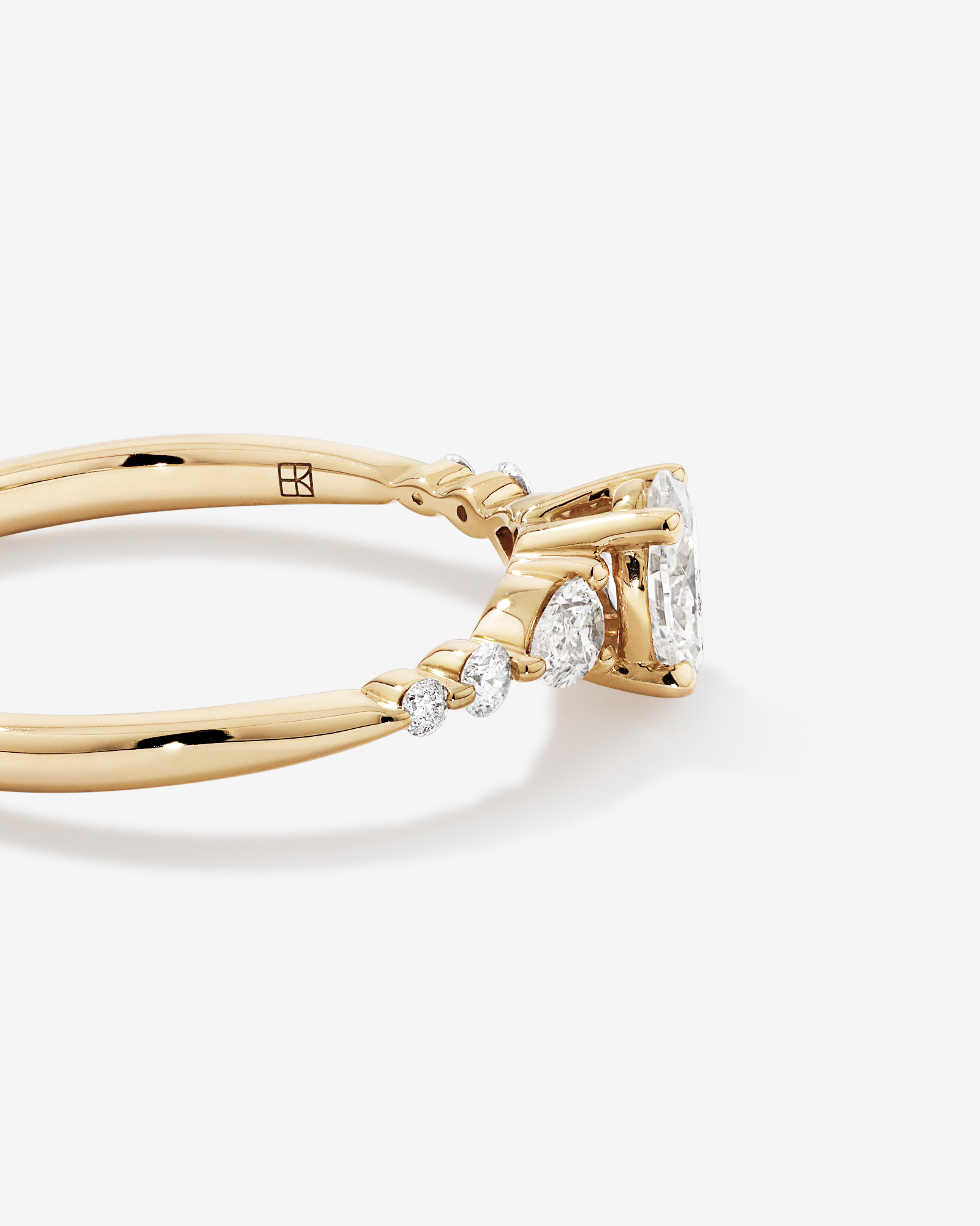 0.59 Carat TW Oval and Pear Sidestone Engagement Ring in 14kt Yellow Gold