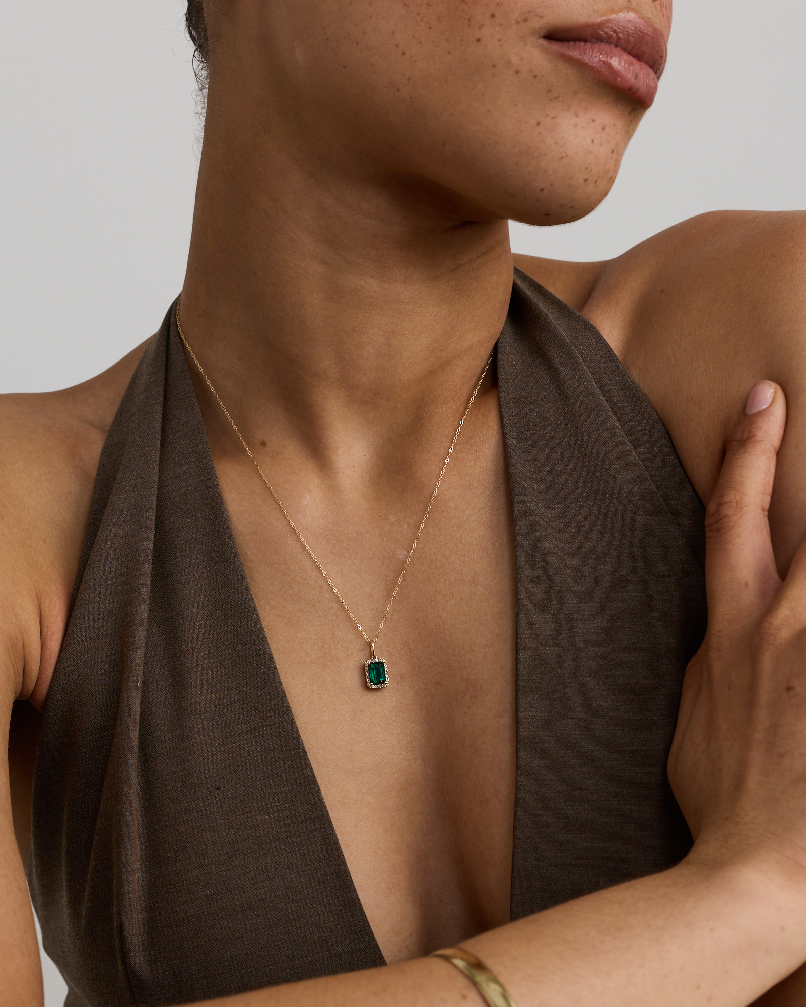 Emerald Cut Green Created Emerald Gemstone and  Diamond Halo Pendant with Chain in 10kt Yellow Gold