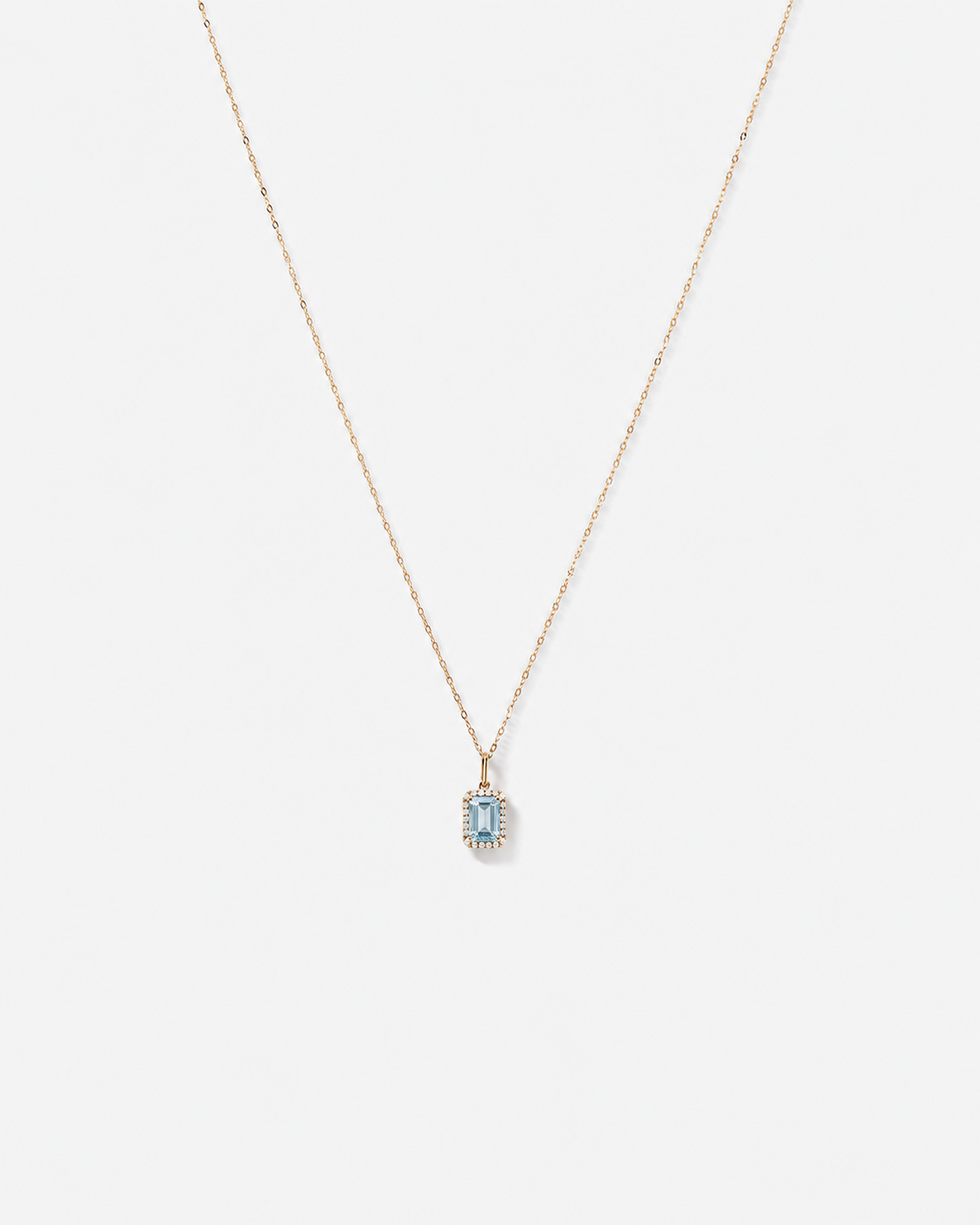 Emerald Cut Blue Topaz and Diamond Halo Pendant with Chain in 10kt Yellow Gold