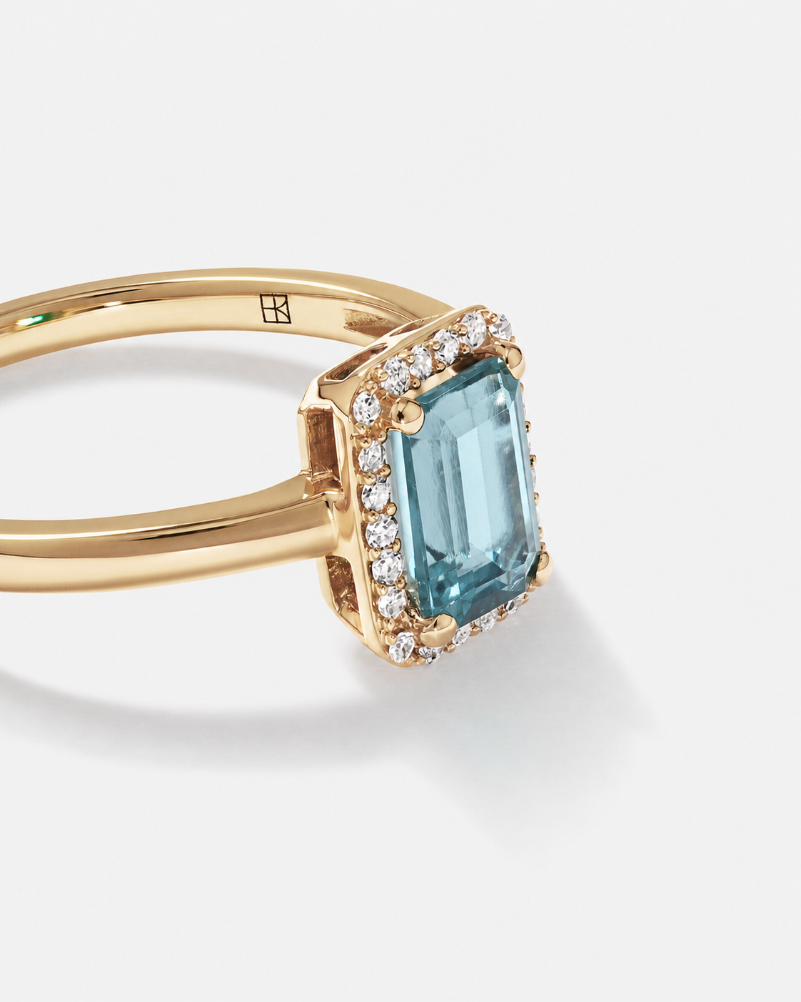 Emerald Cut Blue Topaz and Diamond Halo Ring in 10kt Yellow Gold