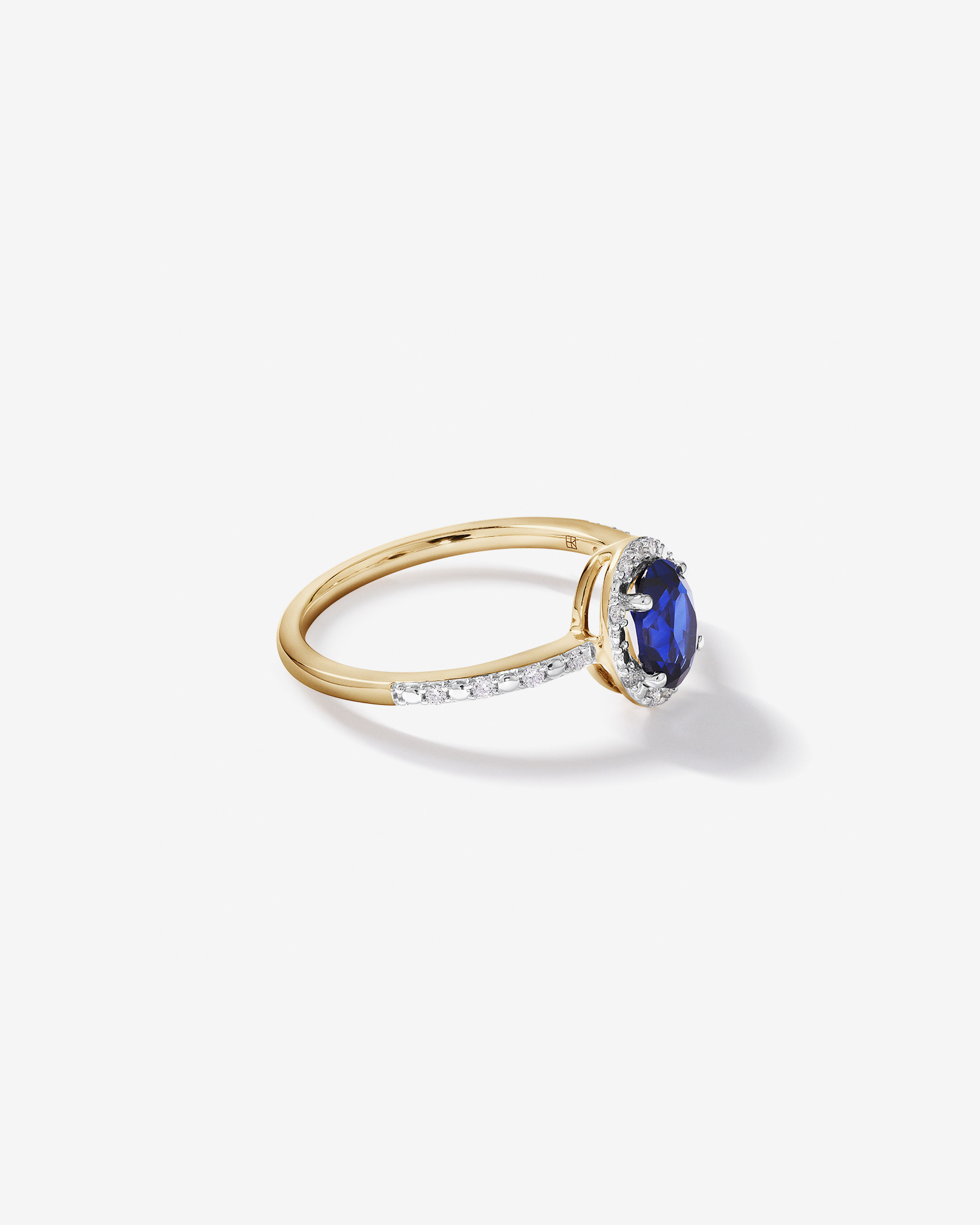 Oval Cut Blue Created Sapphire and Lab-Grown Diamond Halo Ring in 10kt Yellow Gold and Rhodium