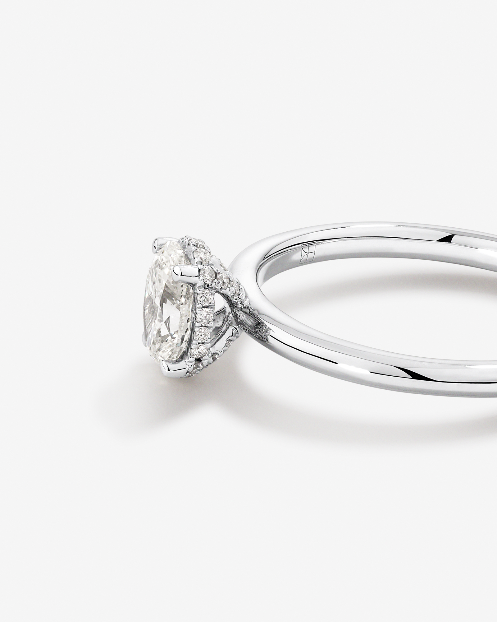 0.68 Carat TW Oval Cut Diamond Solitaire Hidden Pave Halo Engagement Ring in Platinum