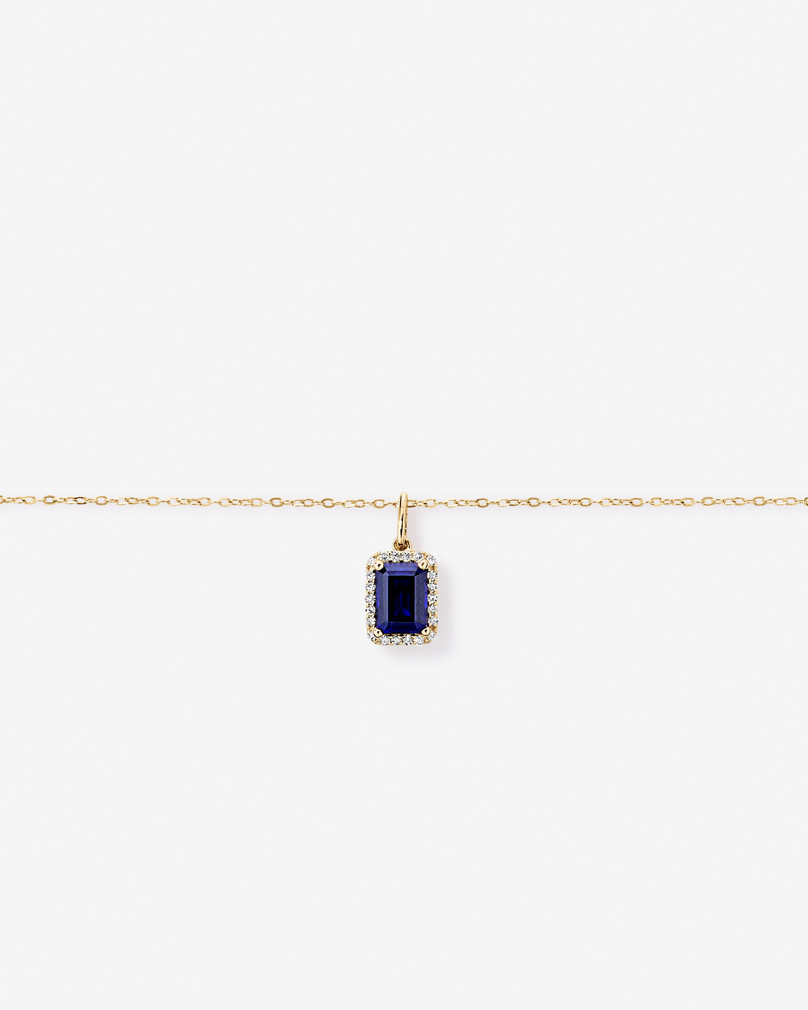 Emerald Cut Created Sapphire and Diamond Halo Pendant with Chain in 10kt Yellow Gold