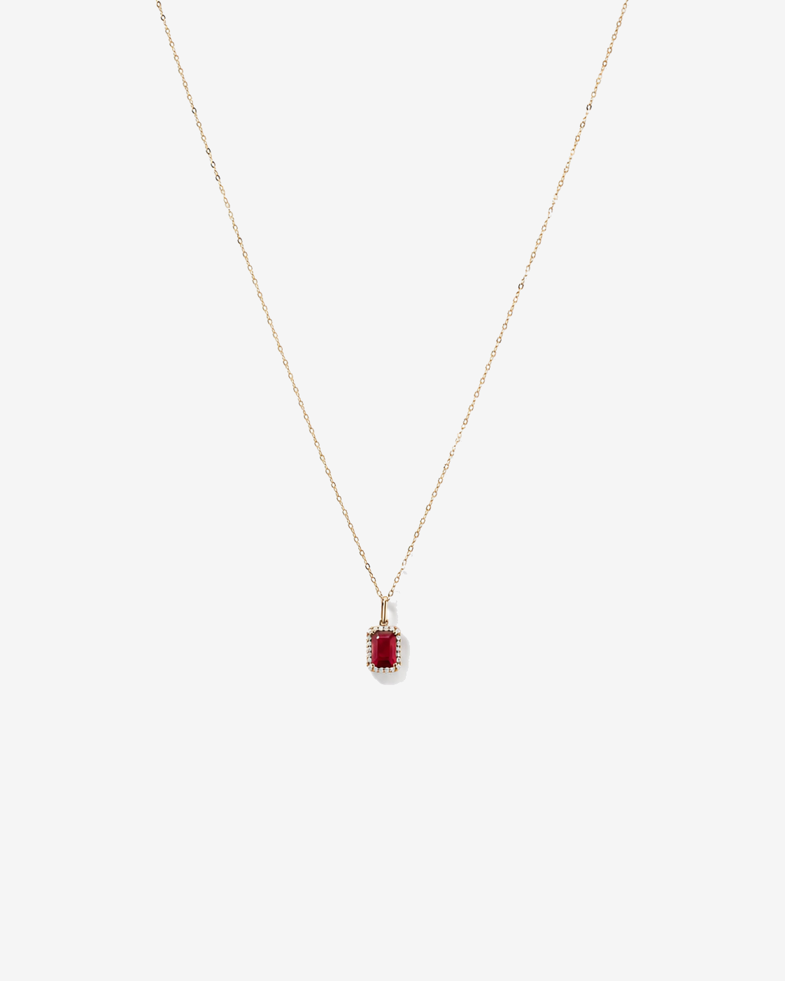 Emerald Cut Created Ruby and Diamond Halo Pendant with Chain in 10kt Yellow Gold