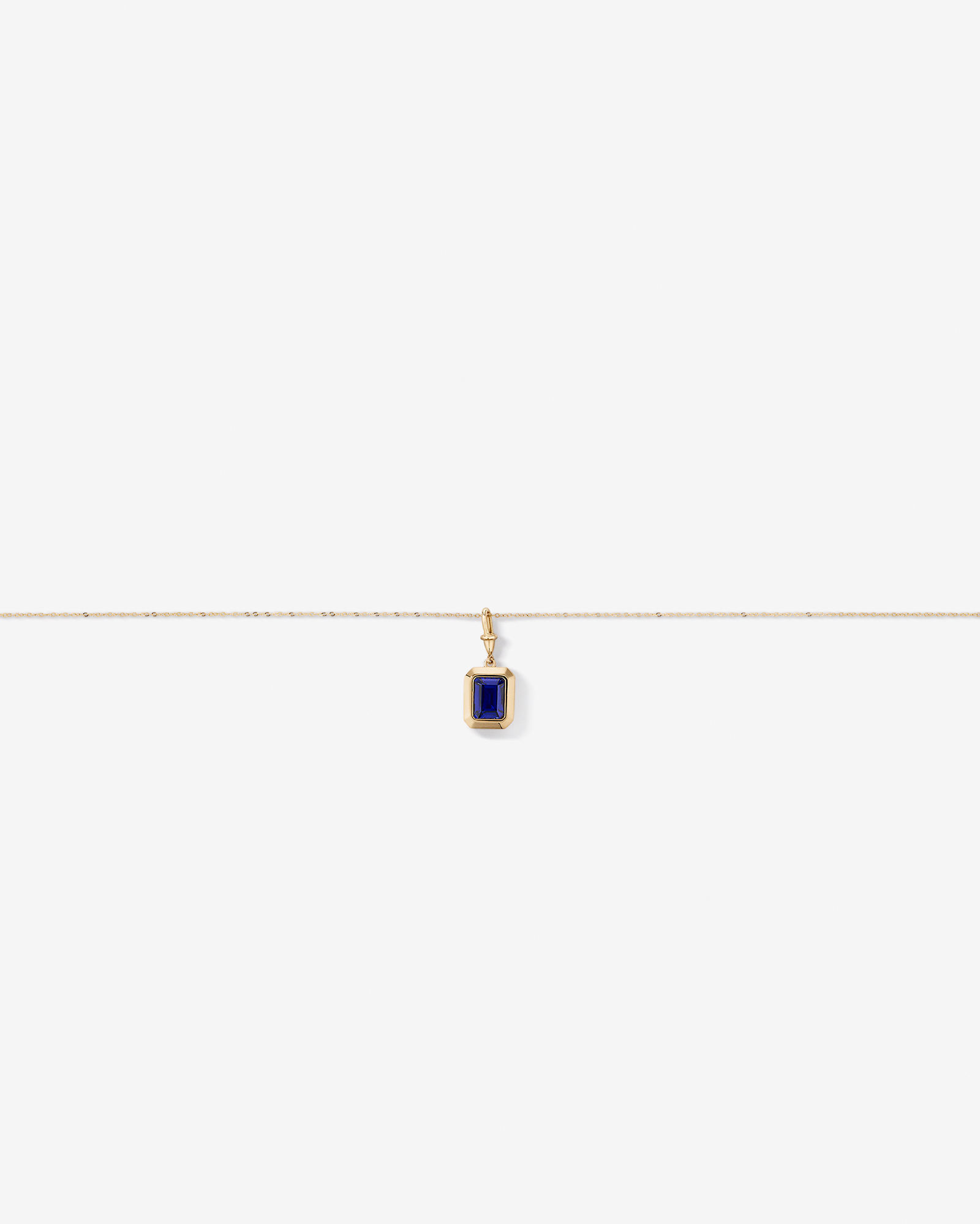 Emerald Cut Created Sapphire Bezel Pendant with Chain in 10kt Yellow Gold