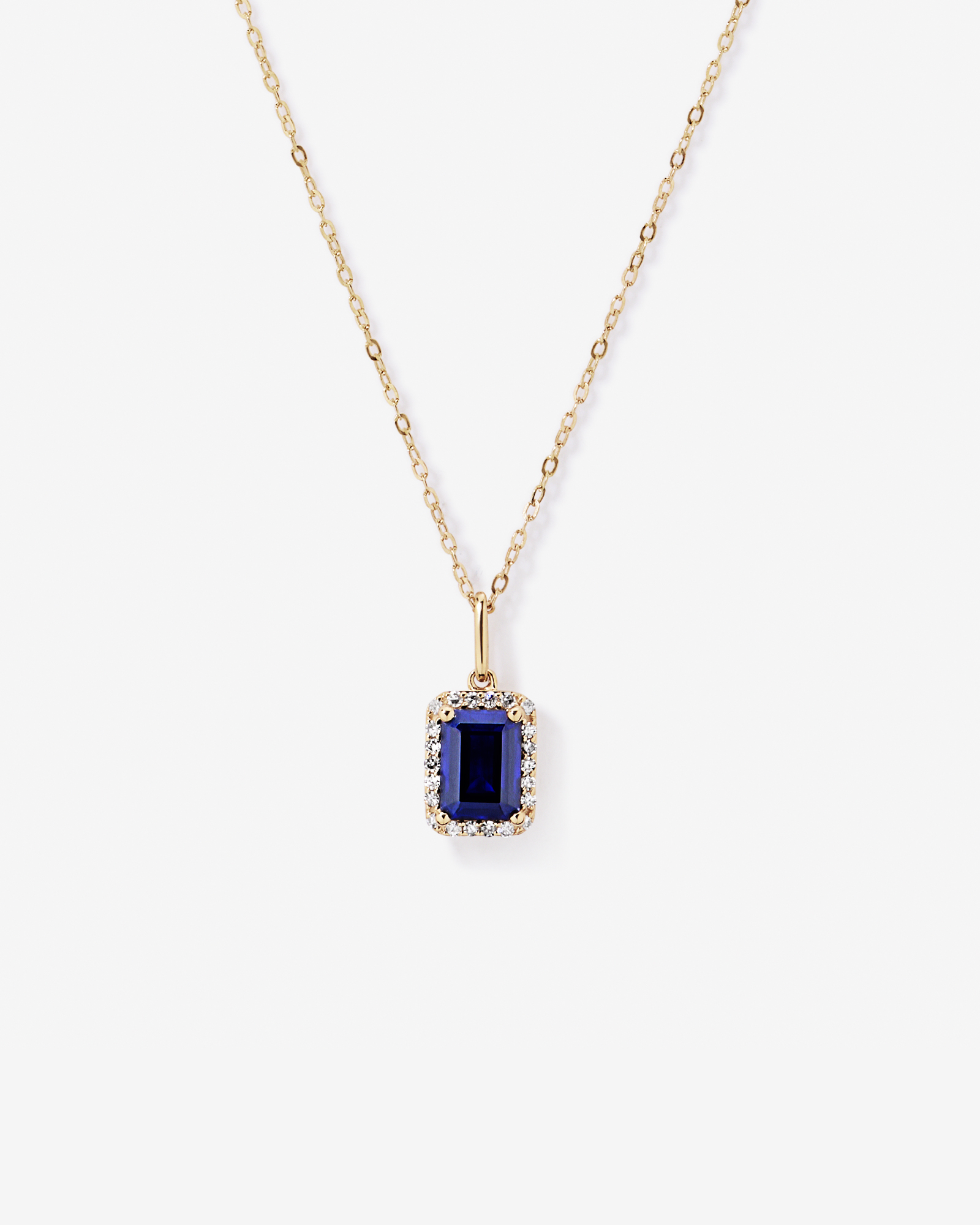 Emerald Cut Created Sapphire and Diamond Halo Pendant with Chain in 10kt Yellow Gold