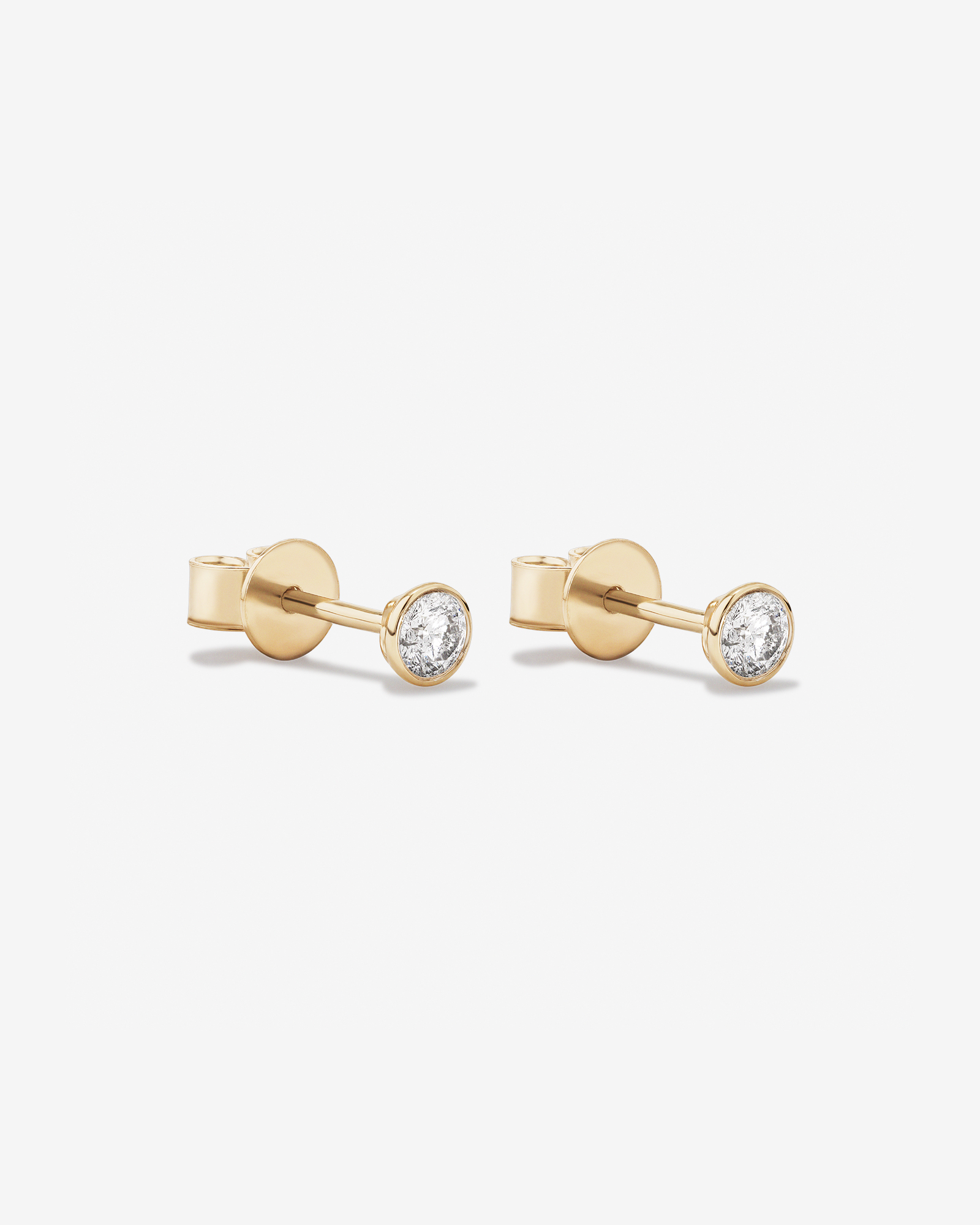 0.25 Carat TW Round Brilliant Diamond Solitaire Bezel Set Stud Earrings 18kt White Gold